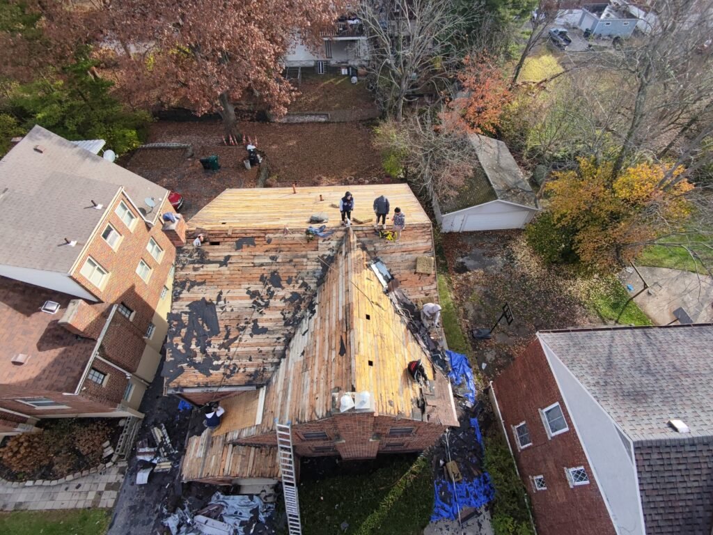 Workers repair house roof shingles. | The Bearded Contractor